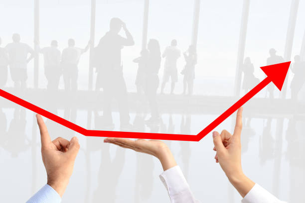 istock Teamwork concept with business people hands steering an arrow suggesting increase sales 650913024
