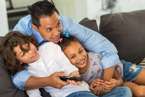 istock Asian Father Watching TV With Children 650921654