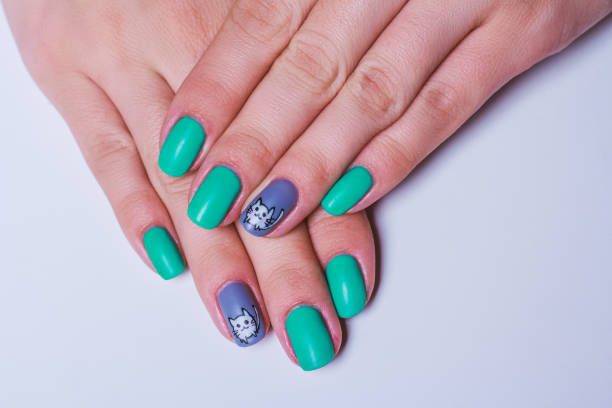 istock Nail art in turquoise with white cat on grey 650936408