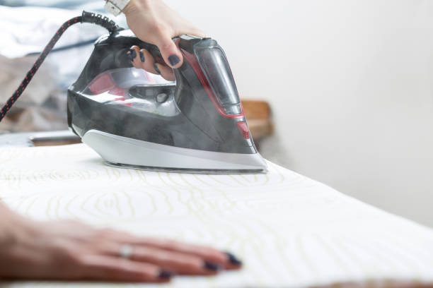 istock Woman uses irons, ironing at home. 650966024