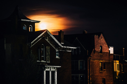 Full moon behind abandoned buildings. Detroit, MI.