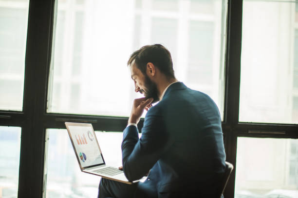 istock Manager with a laptop, working  financial charts near  la 650980870