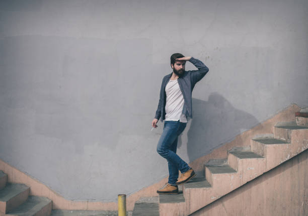 Handsome bearded man going down the stairs