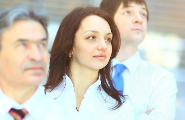 istock Successful business group in a row smiling and looking up 650987772