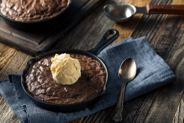 Homemade Sweet Dark Chocolate Brownie in a Skillet Homemade Sweet Dark Chocolate Brownie in a Skillet Ready to Eat walnut cookies stock pictures, royalty-free photos & images
