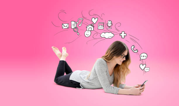 istock Woman relaxed using phone with icons 650996610