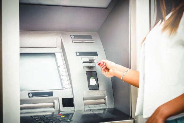 istock Woman taking credit card from atm 650997296
