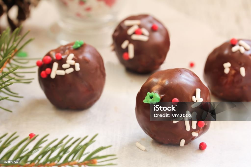 Christmas cake balls covered in chocolate Ganache, selective focus Homemade Christmas cake balls covered in chocolate Ganache with holiday sprinkles, selective focus Cake Stock Photo