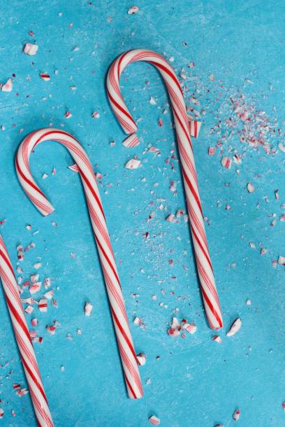 istock Christmas background with candy canes on blue background 651096976