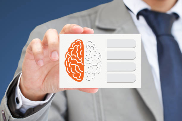istock Businessman hand holding card with brain. 651097016