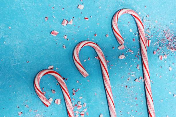 istock Christmas background with candy canes on blue background 651097058