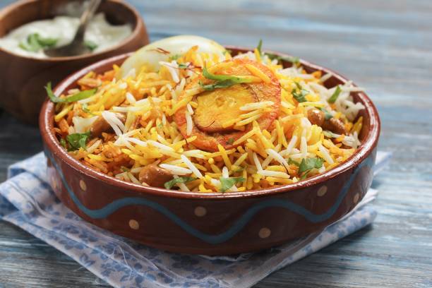 istock Egg Biryani served with yogurt dip on a clay pot, selective focus 651110218