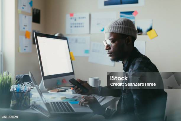 African American Man Working At His Desk Stock Photo - Download Image Now - Computer Programmer, Candid, African-American Ethnicity