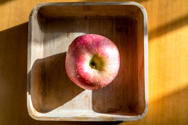 apple in wooden tray