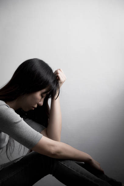 istock depression woman sit on floor 651161504