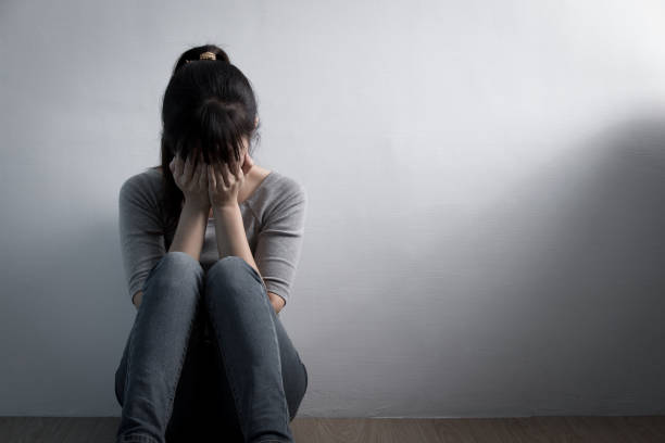 istock depression woman sit on floor 651163052
