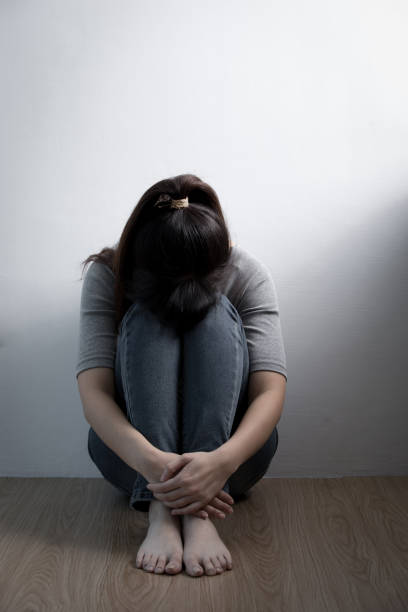 istock depression woman sit on floor 651169066