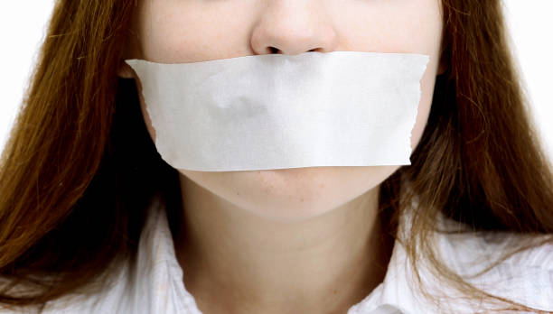 Beautiful girl with the mouth closed, the white ribbon stock photo