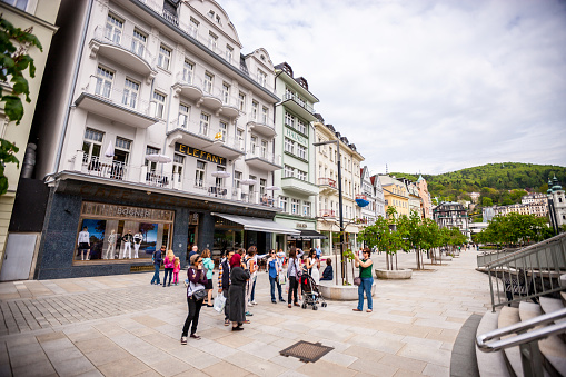Karlovy Vary, Czech Republic - May 5, 2015: Tourists sightseeing and photographing in Karlovy Vary city center