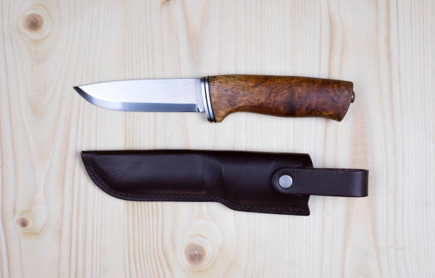 istock Knife and sheath on flat pine wood. 651187198