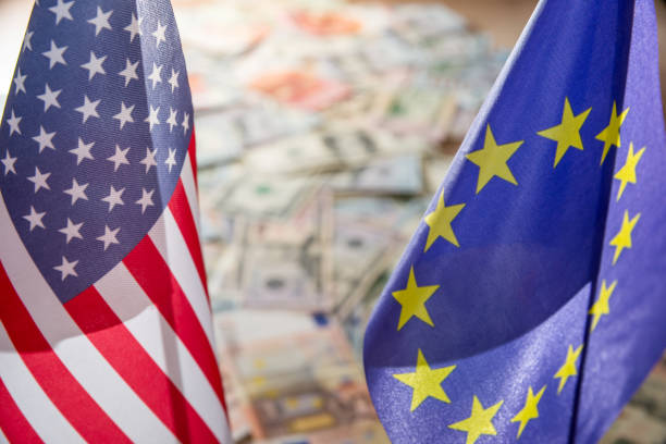 us dollar and euro on flags of the united states and european union. - european union euro note european union currency paper currency currency imagens e fotografias de stock