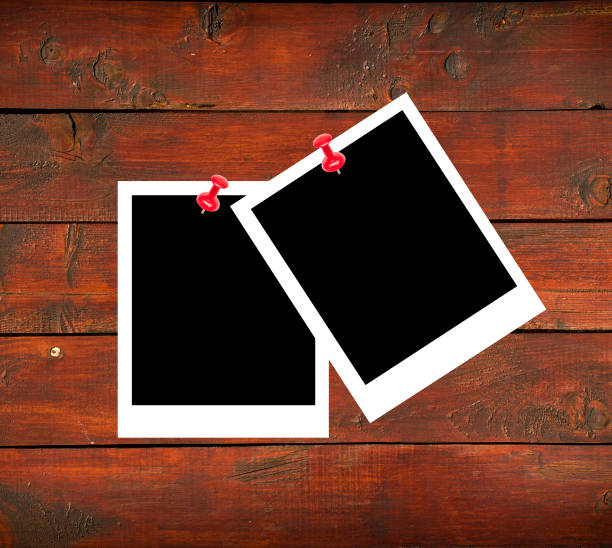 istock Blank photo papers on wooden background 651199584