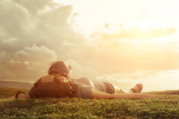 istock Traveler with backpack  looking at sky and clouds over mountains. 651200174