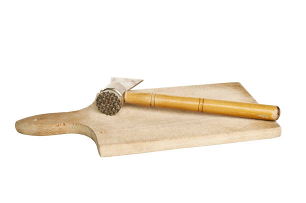 istock Wooden meat hammer on kitchen board isolated on white 651209274