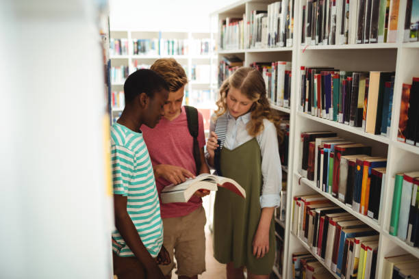 istock School kids reading books in library at school 651218776