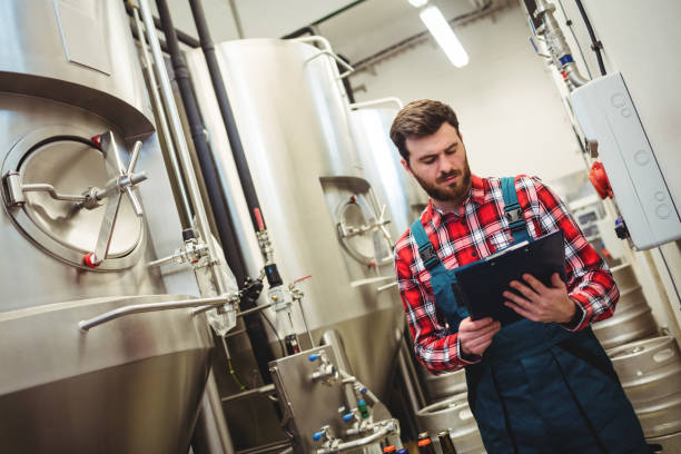 istock Manufacturer holding writing pad in brewery 651221396