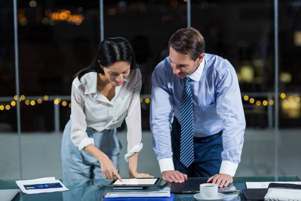 istock Businessman discussing with colleague over digital tablet 651222066