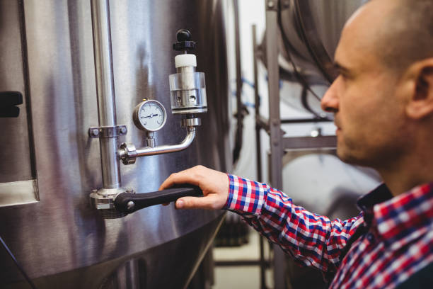 istock Manufacturer adjusting pressure gauge in brewery 651222408