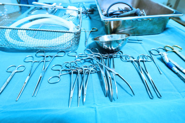 istock Detail shot of steralized surgery instruments with a hand grabbing a tool 651223376