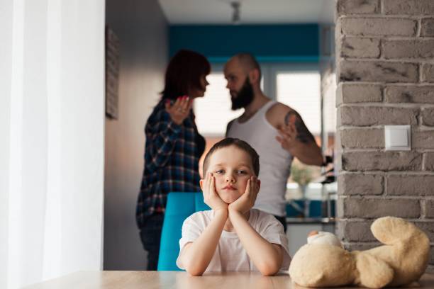 Sad child during parents quarrel Sad child during parents quarrel. Man about to beat his wife arguing couple divorce family stock pictures, royalty-free photos & images