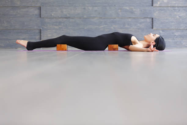 istock Woman practicing yoga indoors. Side stretch for flexibility. 651223724