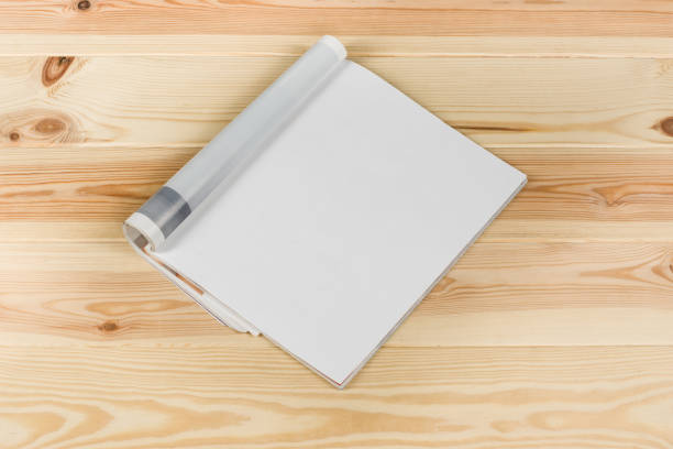 istock Mock-up magazines or catalog on natural wooden table background. 651233188