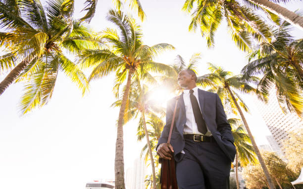 istock businessman walking on the beach in Miami 651233716