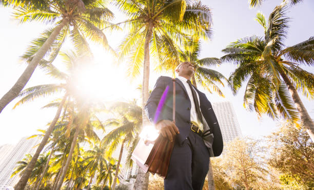 istock businessman walking on the beach in Miami 651235946