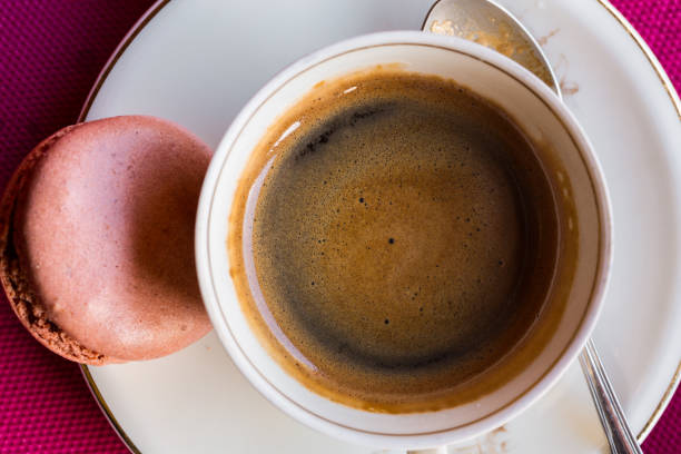 istock cup of coffee and one French macaroon 651236368