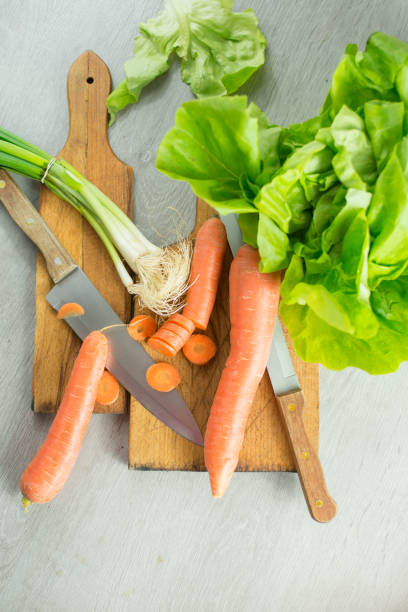 Various vegetables Various vegetables, caroot and spring onion on cutting board on old wooden desk knif stock pictures, royalty-free photos & images