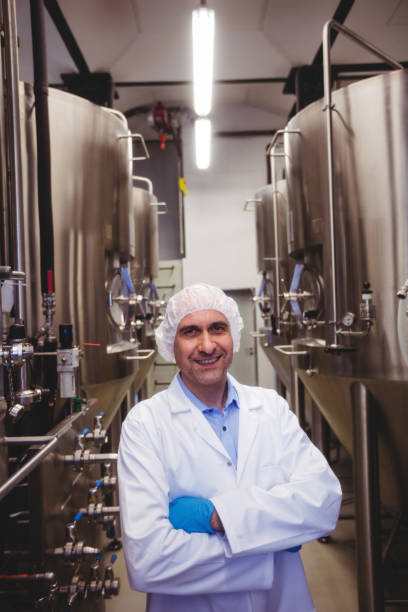 istock Smiling manufacturer standing at brewery 651244452