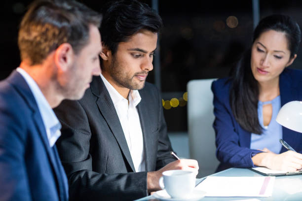 istock Group of businesspeople looking at document 651244550