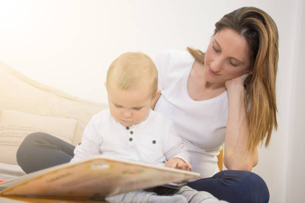 istock Pregnant mother  and her son are reading a book. 651244658
