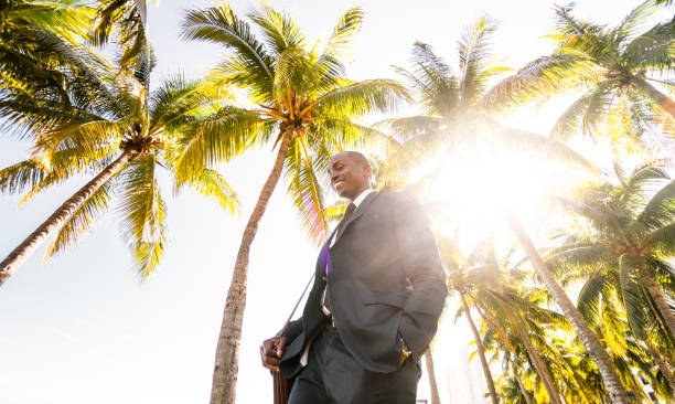 istock businessman walking on the beach in Miami 651247332