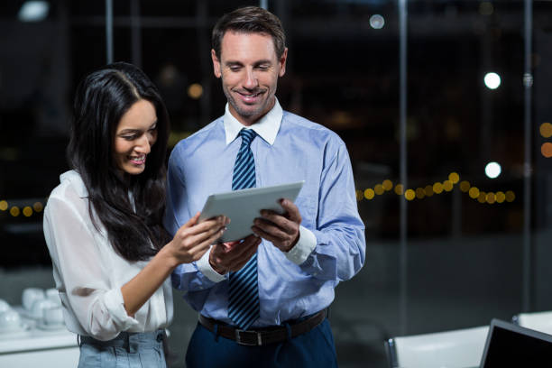 istock Businessman discussing with colleague over digital tablet 651247488