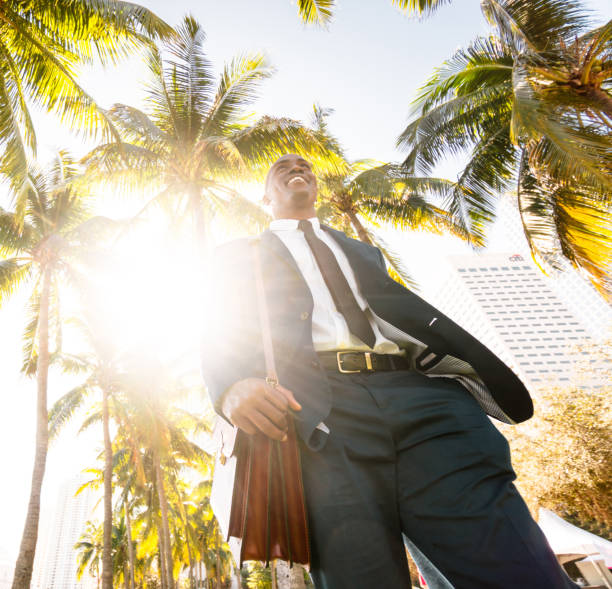 istock businessman walking on the beach in Miami 651247674