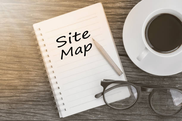 istock Concept Site map message on notebook with glasses, pencil and coffee cup on wooden table. 651247998