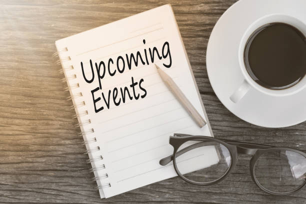 istock Concept Upcoming Events message on notebook with glasses, pencil and coffee cup on wooden table. 651248006