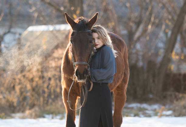 istock Young beautiful elegance modern woman posing with horse 651250576