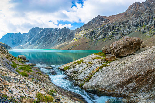 Panorama beautiful emerald-turquoise mountain lake Ala-Kul, Kyrgyzstan.
